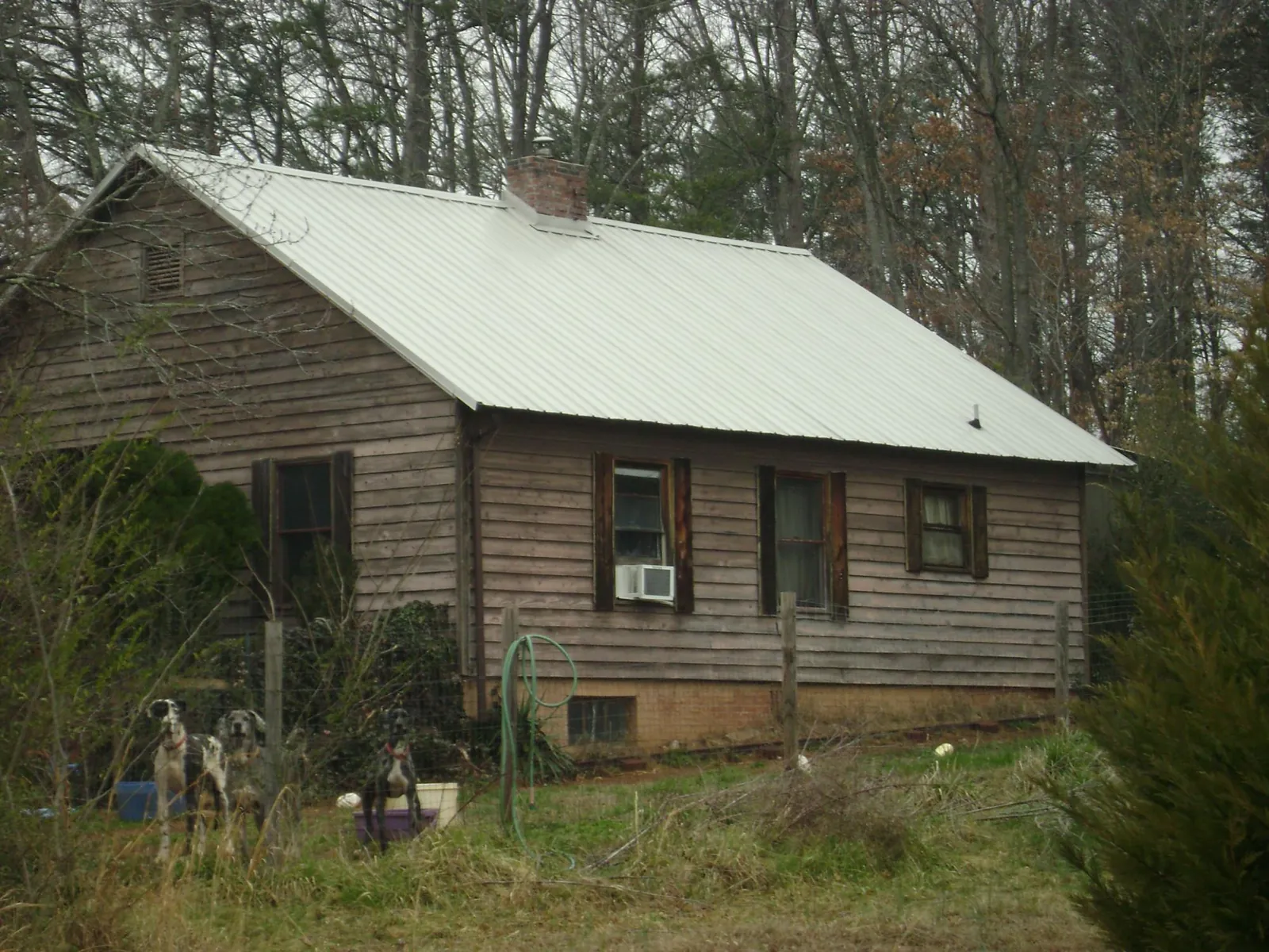 White metal roof on an old wood sided farmhouse, from a Metal Roof Installation job in Hillside
